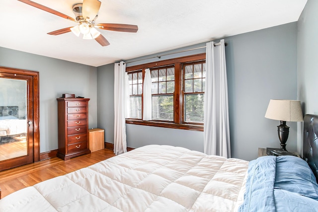 bedroom featuring baseboards, ceiling fan, and wood finished floors