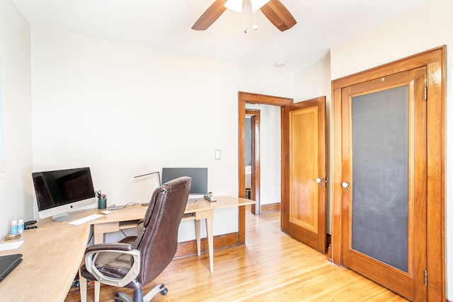 office space with baseboards, light wood finished floors, and ceiling fan