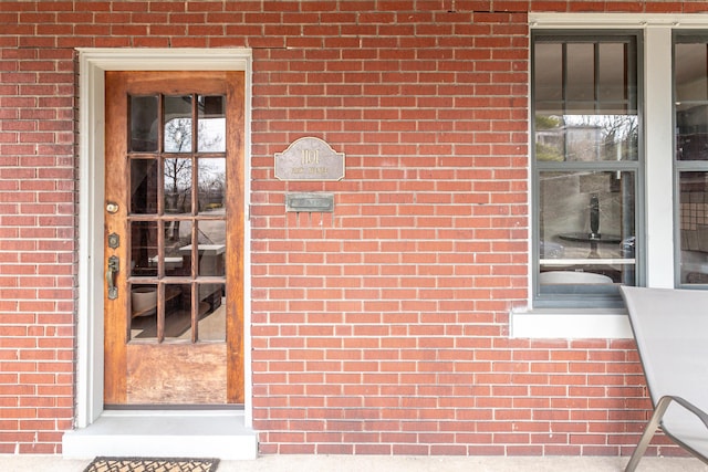 property entrance featuring brick siding