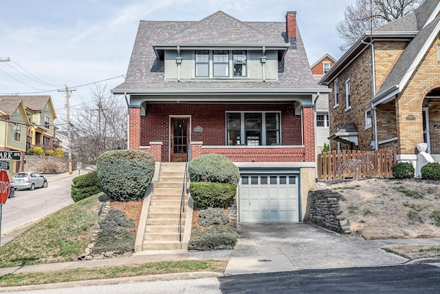 view of front of home with a porch, brick siding, a garage, and driveway