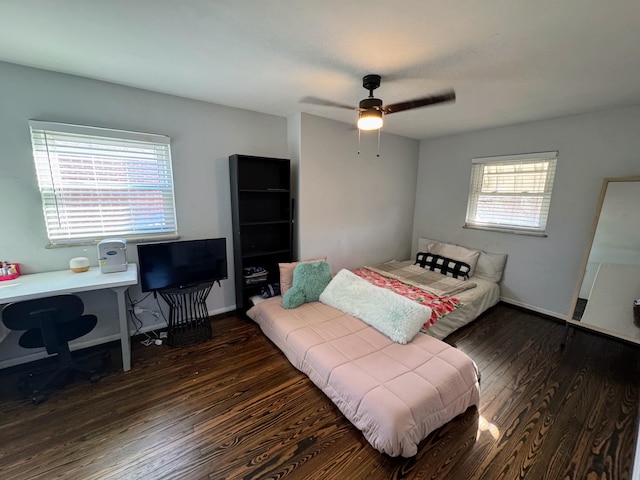 bedroom featuring wood finished floors, baseboards, and ceiling fan