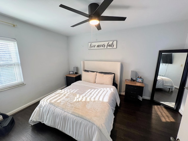 bedroom with a ceiling fan, wood finished floors, and baseboards