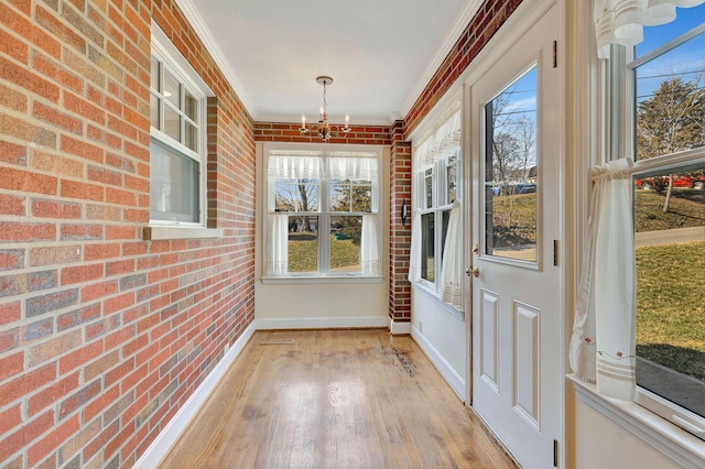 unfurnished sunroom featuring a notable chandelier