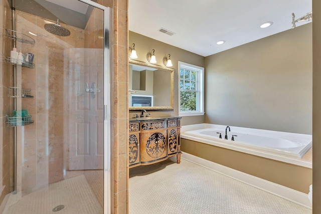 full bath featuring visible vents, a shower stall, vanity, and a garden tub