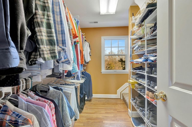 spacious closet featuring wood finished floors and visible vents