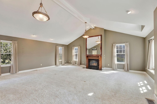 unfurnished living room featuring visible vents, beamed ceiling, a healthy amount of sunlight, and carpet floors