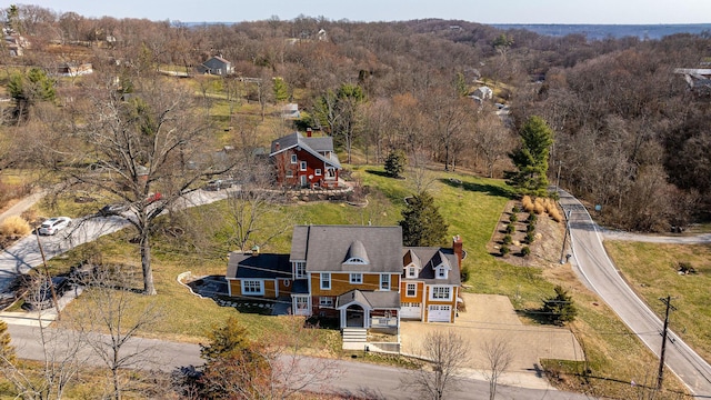 aerial view featuring a wooded view