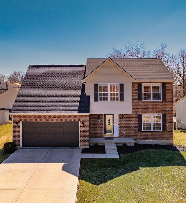 view of front of home featuring roof with shingles, concrete driveway, a front yard, a garage, and brick siding