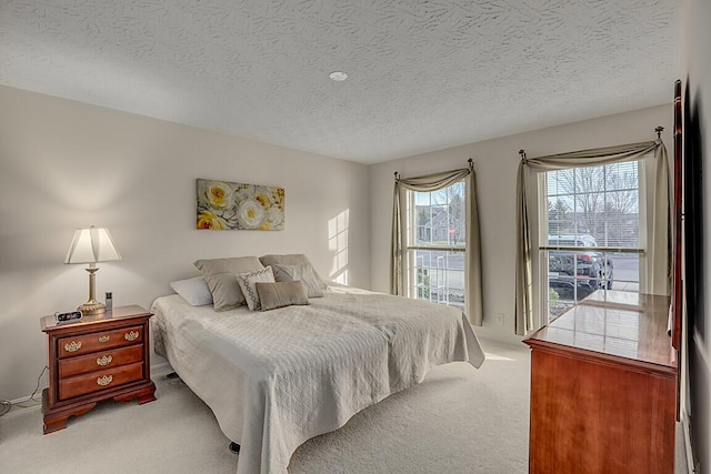 carpeted bedroom with a textured ceiling