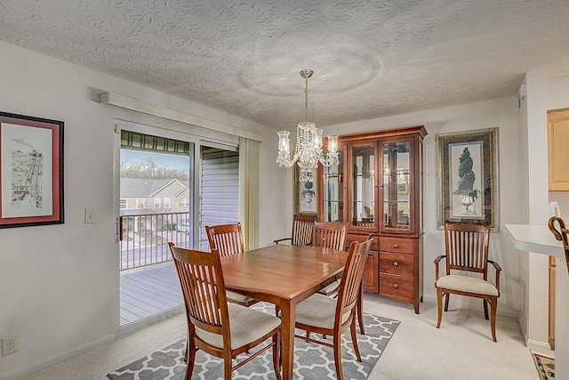 dining area with baseboards, light carpet, a textured ceiling, and an inviting chandelier