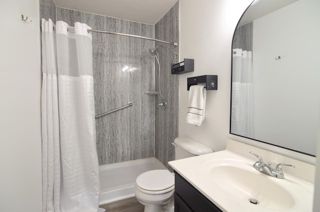 bathroom featuring curtained shower, toilet, and vanity