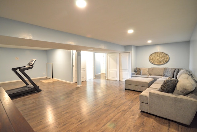 living area featuring recessed lighting, baseboards, and wood finished floors