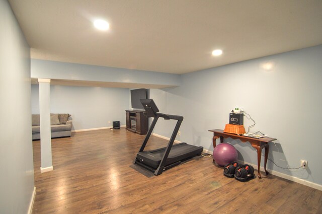 exercise area featuring recessed lighting, baseboards, and wood finished floors