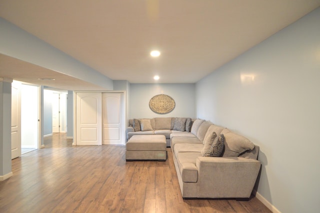 living area featuring recessed lighting, wood finished floors, and baseboards