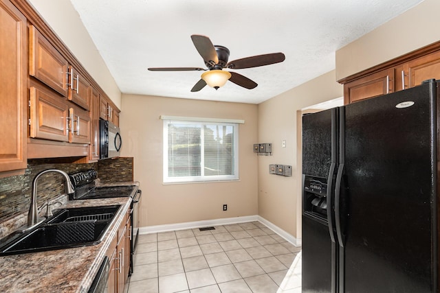 kitchen with backsplash, ceiling fan, brown cabinets, black appliances, and a sink