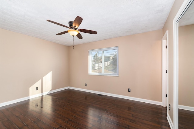 spare room featuring a textured ceiling, baseboards, a ceiling fan, and hardwood / wood-style floors