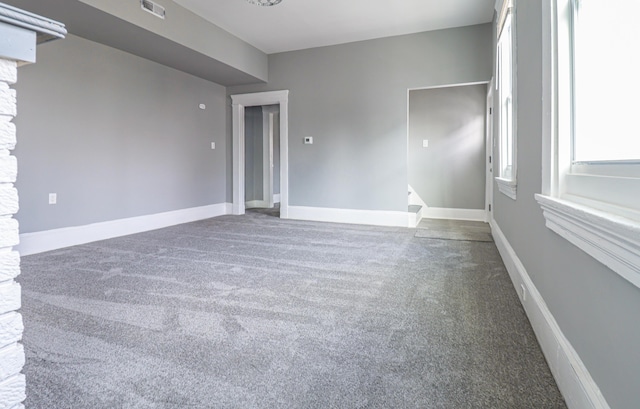 spare room featuring visible vents, baseboards, and carpet floors