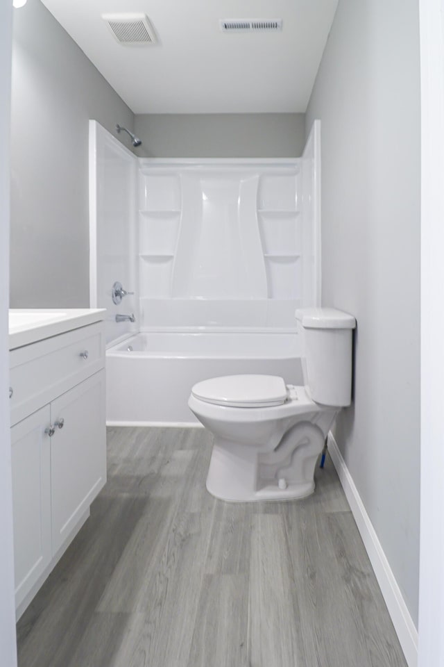 full bathroom featuring toilet, wood finished floors, and visible vents