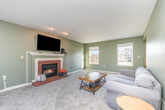 living room featuring carpet, a fireplace, and baseboards