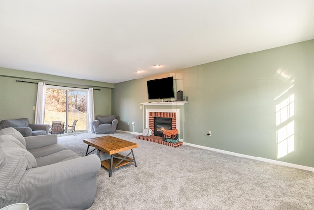 living room featuring a fireplace, baseboards, and carpet floors