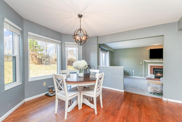 dining room featuring wood finished floors, a wealth of natural light, and a chandelier