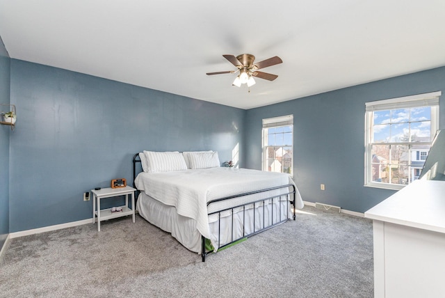 carpeted bedroom featuring visible vents, ceiling fan, and baseboards