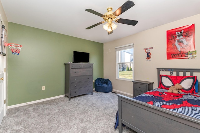 carpeted bedroom featuring baseboards and ceiling fan