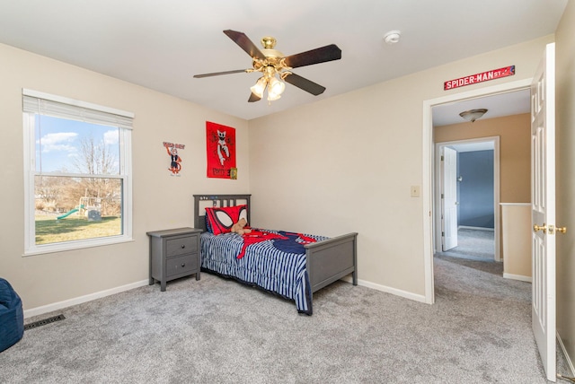 carpeted bedroom featuring visible vents, a ceiling fan, and baseboards