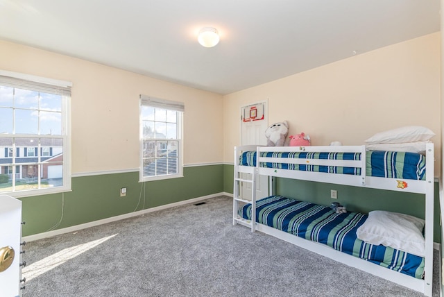 carpeted bedroom with visible vents and baseboards