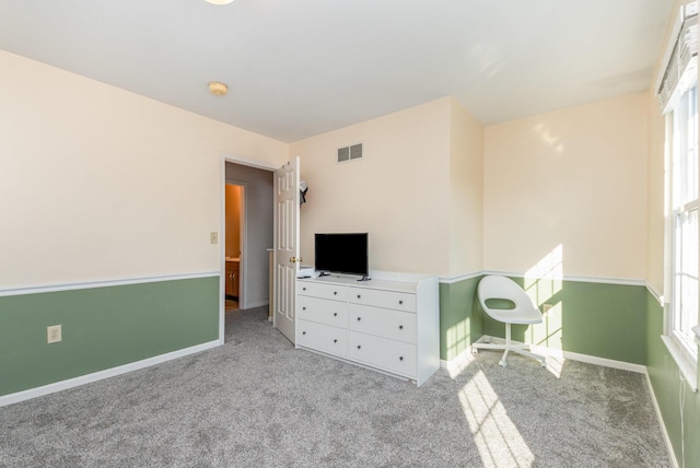 unfurnished bedroom with carpet, visible vents, and baseboards