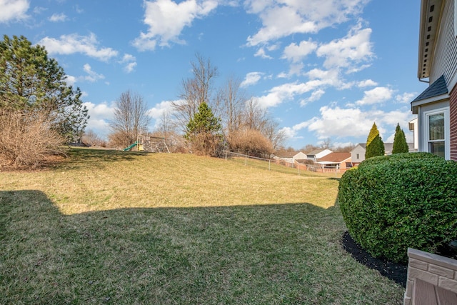 view of yard with fence and a playground