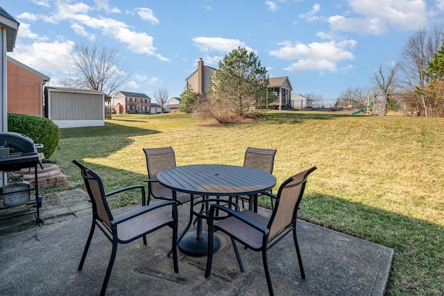 view of patio with area for grilling, outdoor dining area, and a playground