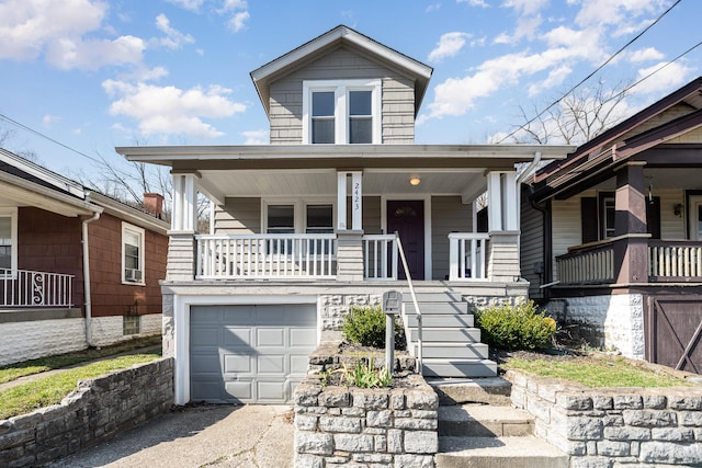 view of front of house with stairway, a porch, an attached garage, and driveway