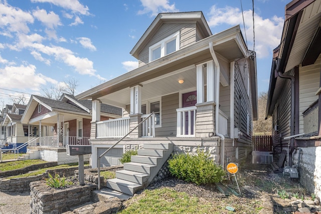 view of front of house with stairway and covered porch