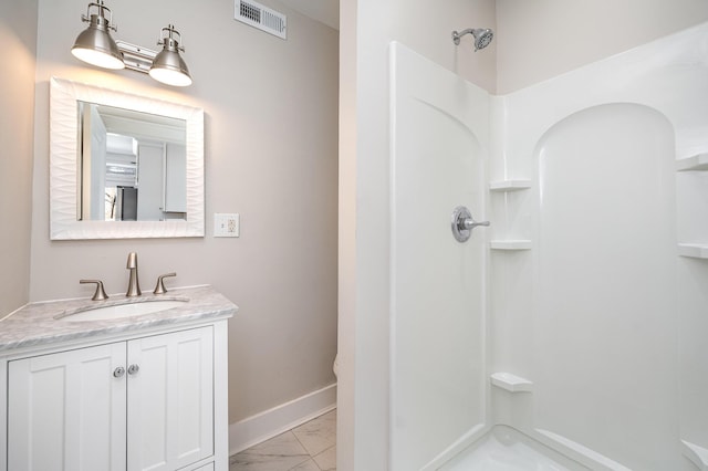 bathroom featuring visible vents, baseboards, walk in shower, marble finish floor, and vanity