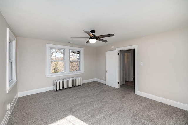 carpeted empty room with baseboards, a ceiling fan, and radiator heating unit