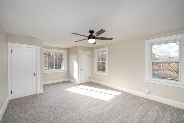 unfurnished bedroom with visible vents, carpet flooring, baseboards, and multiple windows