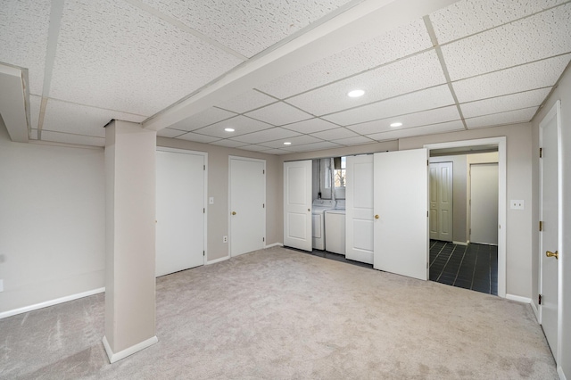 finished basement featuring carpet flooring, washing machine and dryer, recessed lighting, and a drop ceiling