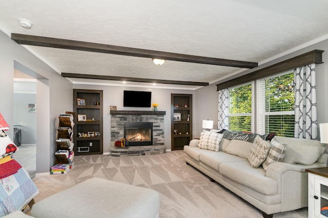 carpeted living room with a stone fireplace, beam ceiling, built in features, and a textured ceiling