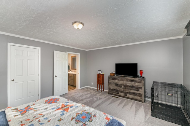 bedroom featuring a sink, a textured ceiling, carpet floors, crown molding, and baseboards