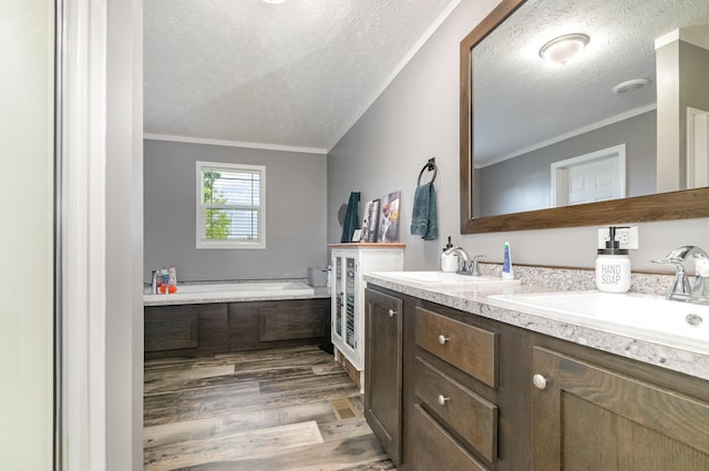 full bath with a bath, ornamental molding, double vanity, and wood finished floors