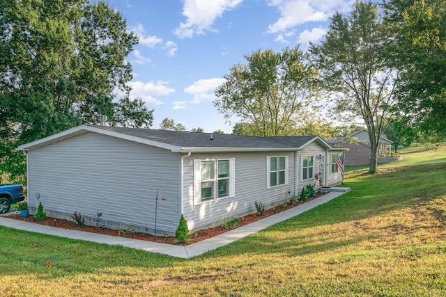 view of side of property featuring crawl space and a yard