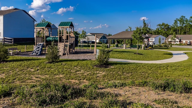 community play area featuring a lawn and a residential view