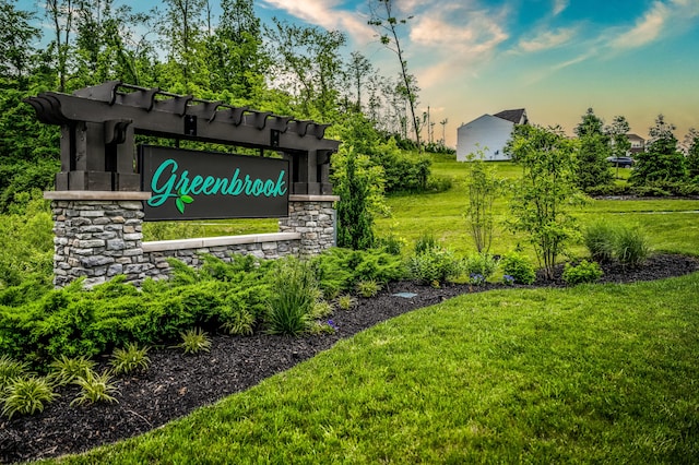 community / neighborhood sign with a lawn