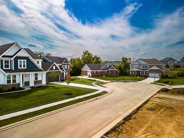 view of front of property with a residential view, curved driveway, board and batten siding, and a front yard