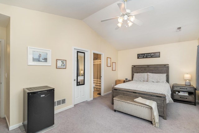 carpeted bedroom with visible vents, lofted ceiling, and baseboards