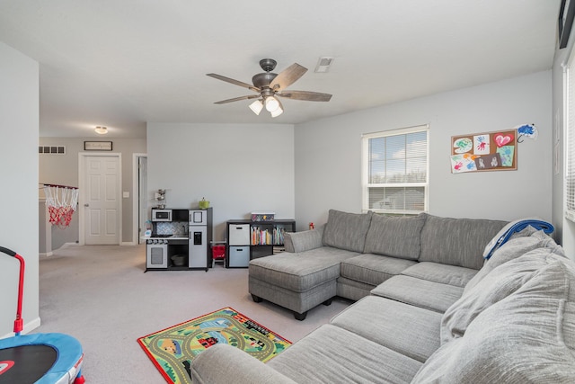 carpeted living room with visible vents and ceiling fan