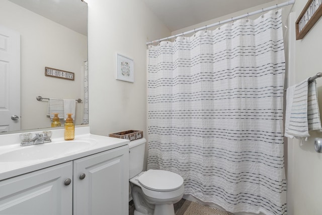 full bathroom featuring vanity, curtained shower, and toilet