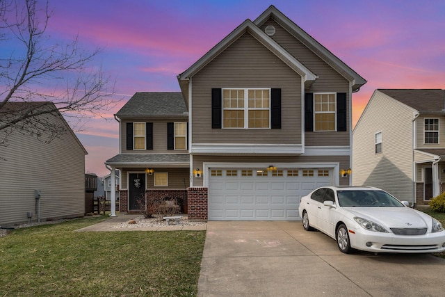 traditional-style house with a front yard, roof with shingles, an attached garage, concrete driveway, and brick siding