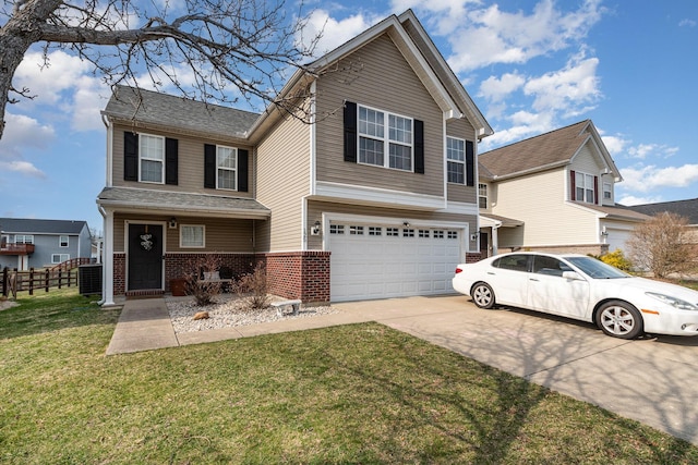 traditional-style home featuring fence, an attached garage, concrete driveway, a front lawn, and brick siding